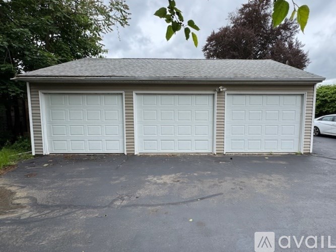 A two-car garage with a grey roof and white doors.