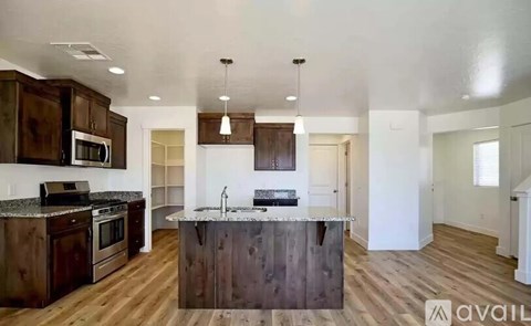 A kitchen with dark wood cabinets and a central island.