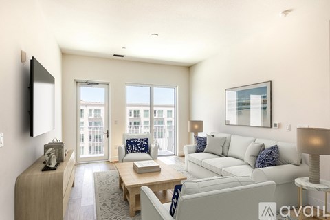 A living room with a white couch and a wooden coffee table.