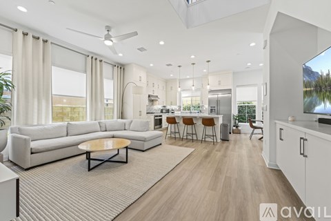 A spacious living room with a large sectional sofa and a coffee table in the center.