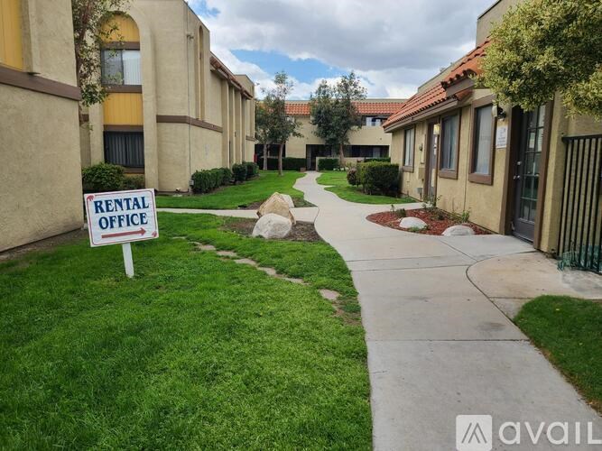 A rental office sign is in front of a building.