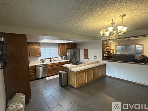 A kitchen with wooden cabinets and a stainless steel sink.