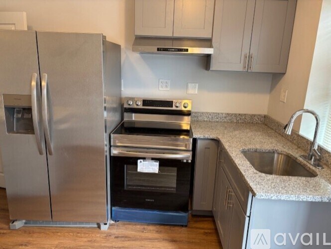 A kitchen with a stainless steel refrigerator and oven.