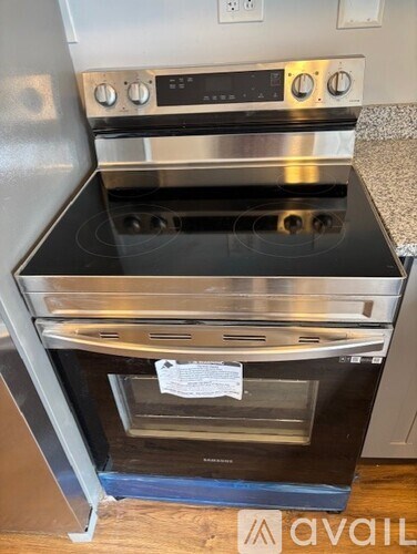 A stainless steel oven with a glass door and control panel.