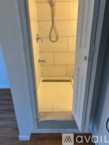 A bathroom with a walk-in shower and a door.