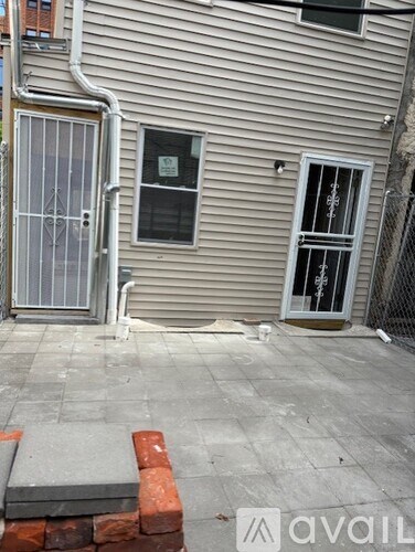 A grey house with a window and a door.