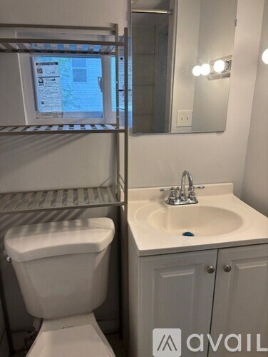 A white toilet is next to a sink in a small bathroom.