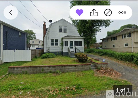 A house with a grey front and a white fence.