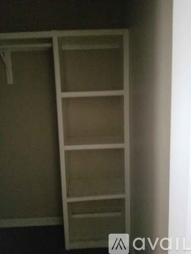 A white ladder leaning against a wall.