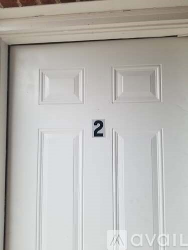 A white door with a number 2 on it.
