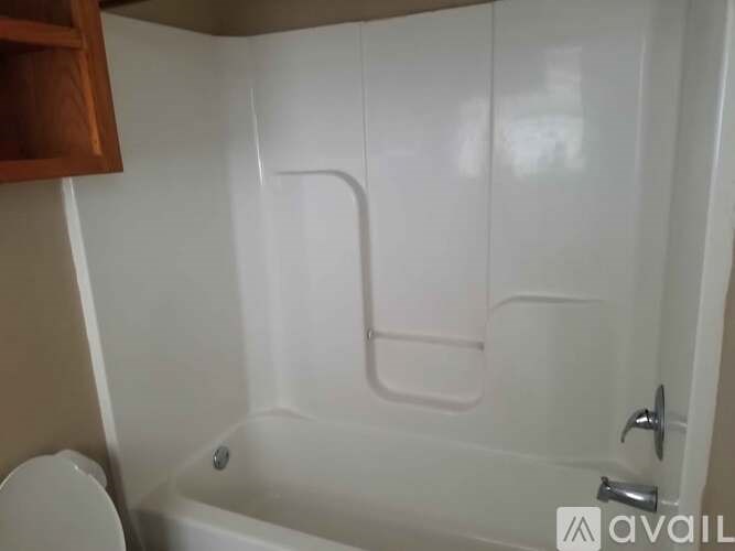 A white bathroom with a toilet and a bathtub.