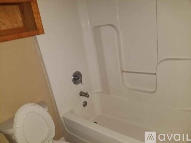 A white bathtub with a silver faucet and a white lid.