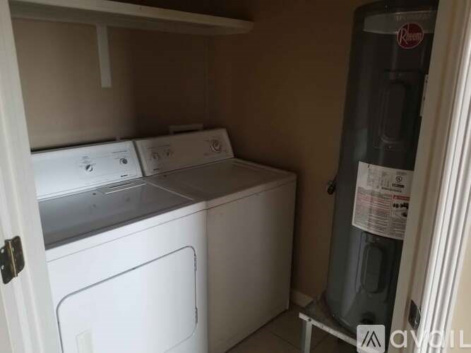 A small laundry room with a washer and dryer.