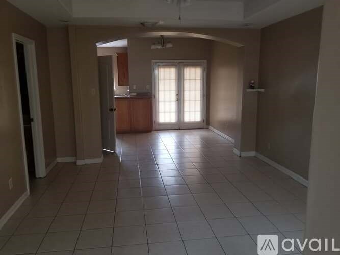 A room with a tile floor and a ceiling fan.