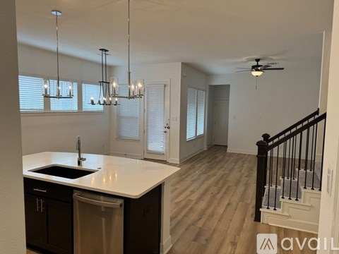 A kitchen with a sink and a dishwasher.