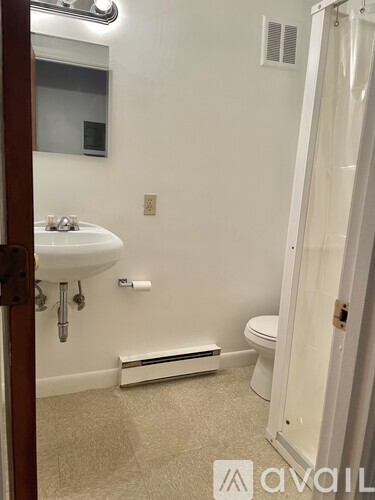 A bathroom with a sink, toilet, and shower.