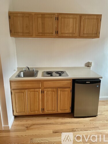 A kitchen with wooden cabinets and a dishwasher.