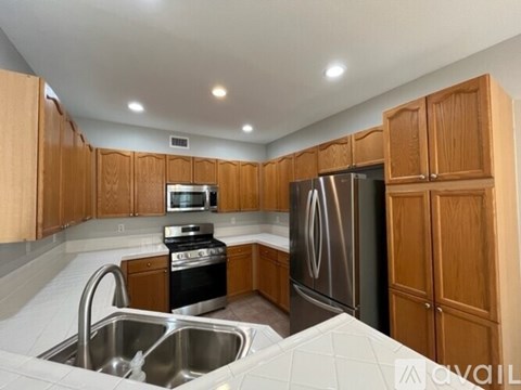 A kitchen with wooden cabinets and stainless steel appliances.