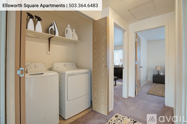 A laundry room with a washer and dryer in Ellsworth Square Apartments.