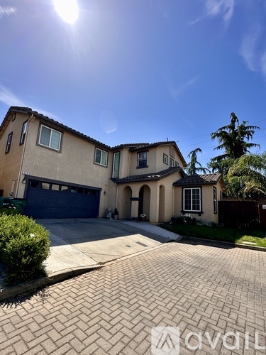 A house with a driveway and a blue garage door.
