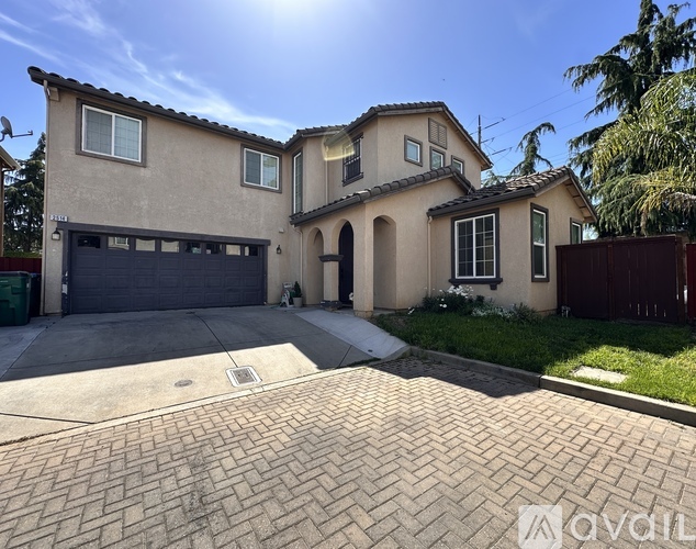 A house with a garage and a driveway in front.