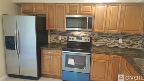 A kitchen with wooden cabinets and a blue oven.