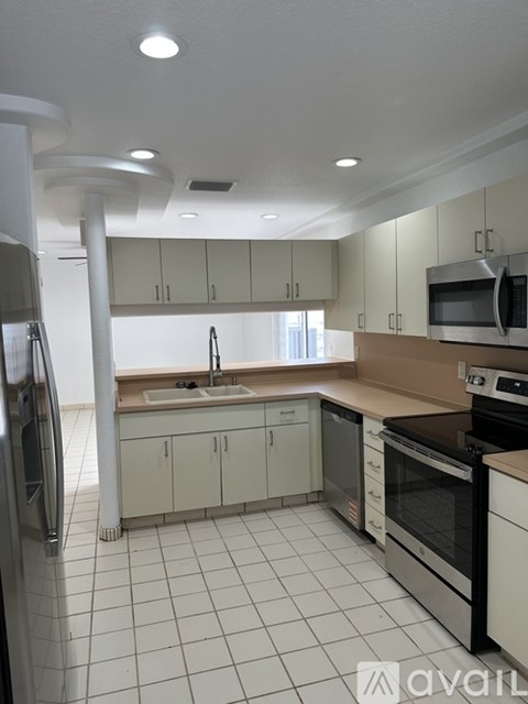 A kitchen with white cabinets and appliances.