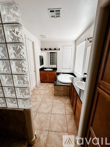 A small kitchen with a refrigerator and a sink.