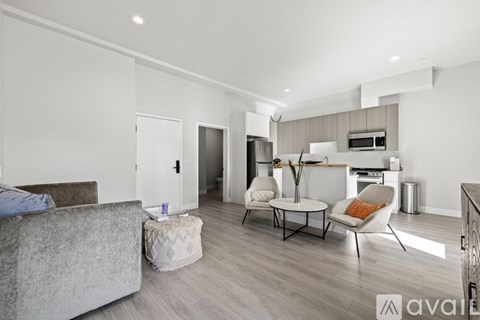A living room with a grey couch and a coffee table.