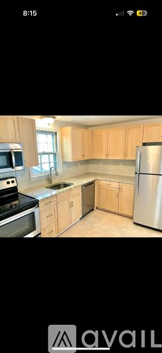A kitchen with wooden cabinets and stainless steel appliances.