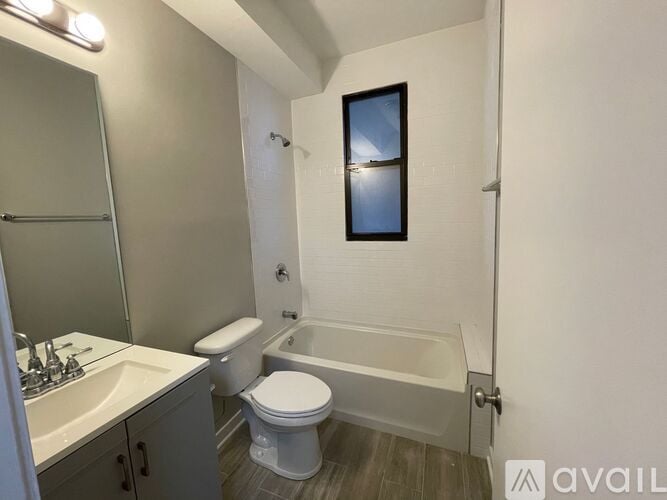 A bathroom with a toilet, sink, and bathtub.