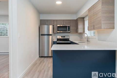A kitchen with a stainless steel refrigerator and a white countertop.