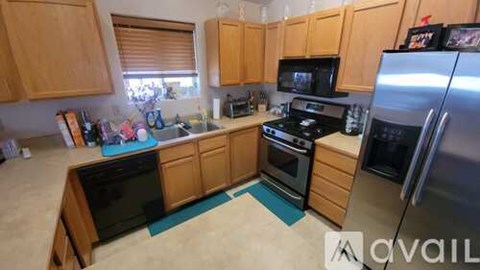 A kitchen with wooden cabinets and a black stove top oven.