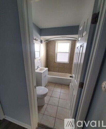 A bathroom with a toilet, sink, and bathtub.