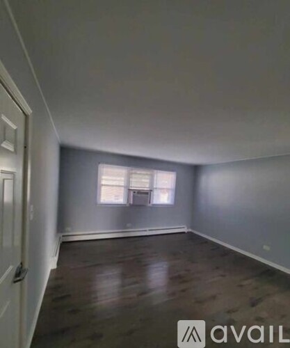 A room with wooden floors and a window.