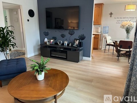 A living room with a wooden coffee table and a blue sofa.