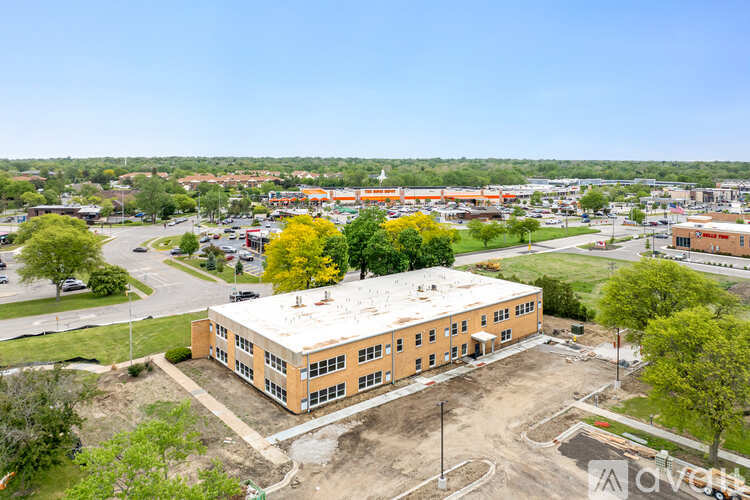 A large building with a parking lot in front of it.