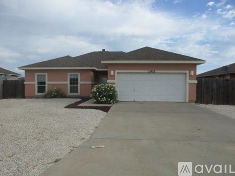 A house with a garage and a driveway in front.