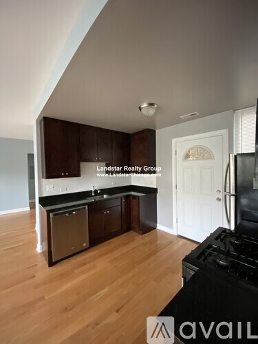 A kitchen with wooden cabinets and a black stove top oven.