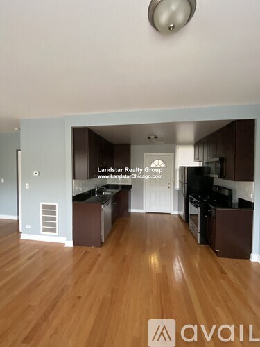 A kitchen with wooden floors and a logo that reads "avail".