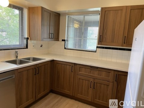 A room with a window covered by blinds and a radiator on the wall.