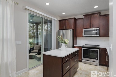 A kitchen with wooden cabinets and a white countertop.