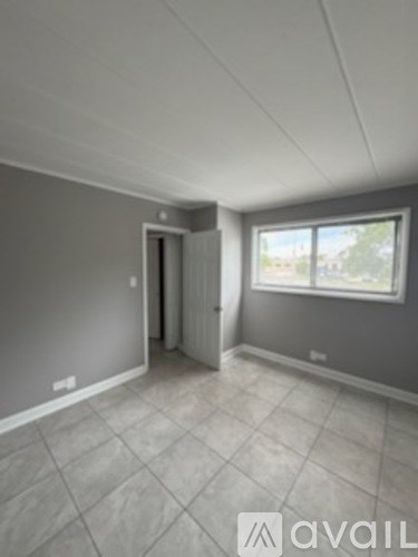 A room with grey walls and a tiled floor.