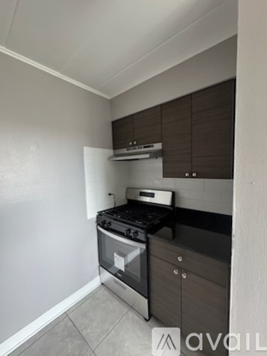 A kitchen with a stove top oven and a wall-mounted microwave.