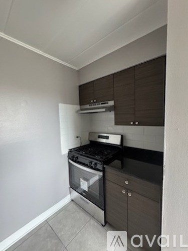 A kitchen with a stove top oven and a wall-mounted microwave.
