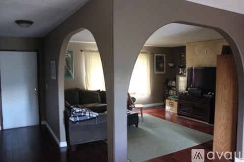 A living room with a couch and a television.