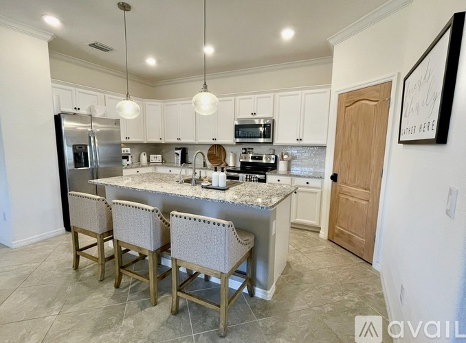 A dining room with a table and chairs.