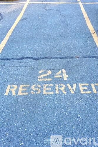 A parking space is marked with the number 24 and the word reserved.