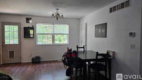 A dining room with a table and chairs.
