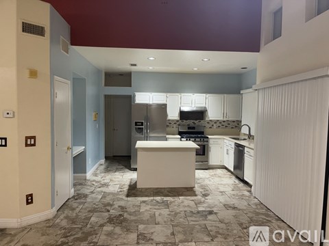 A kitchen with a large island in the middle.